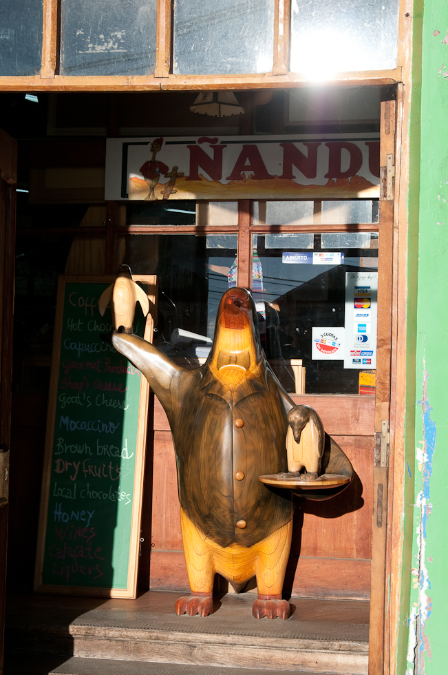 Wood penguin at shop entrance   Puerto Natales, Chile